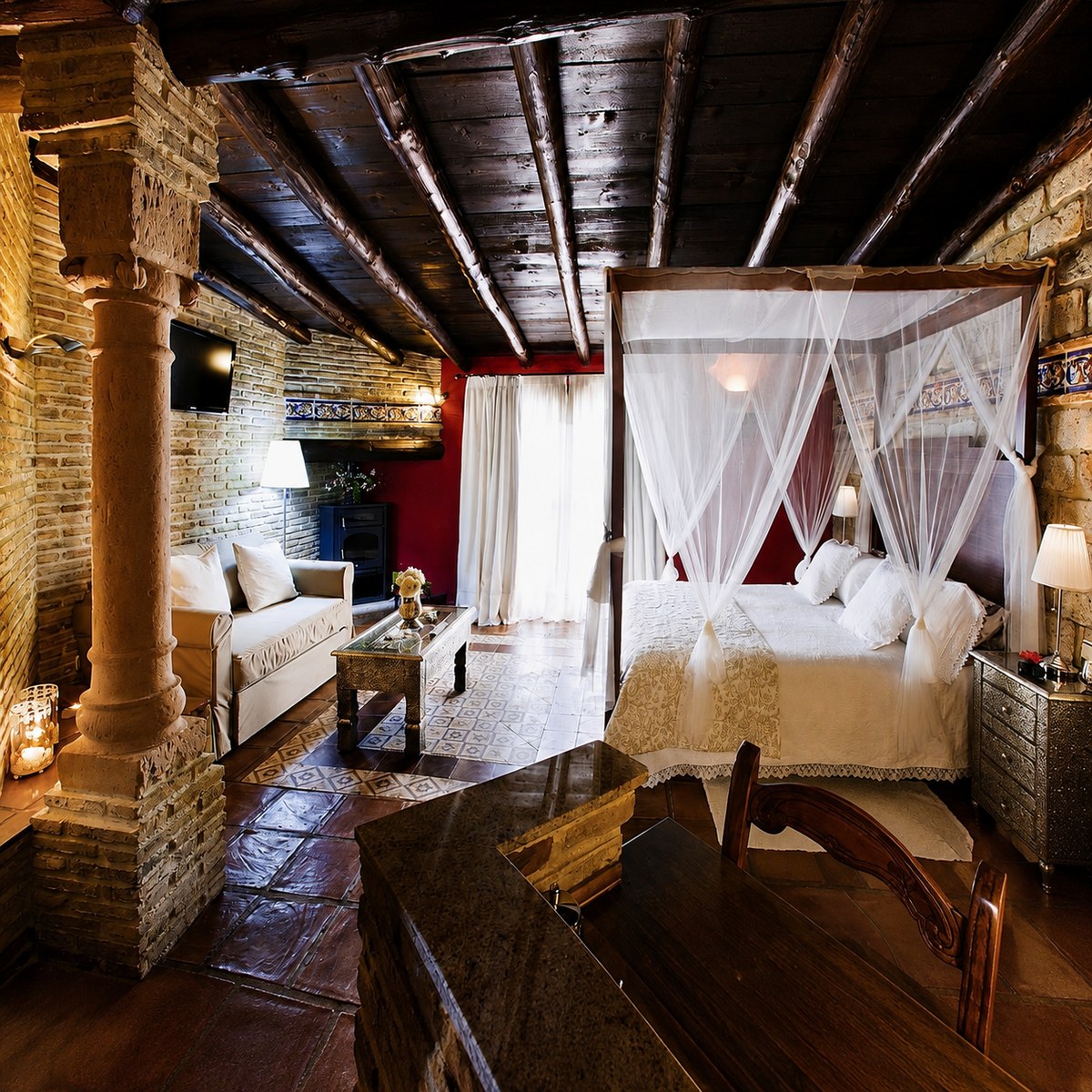 Rustic suite with a four-poster bed at The Ridge accommodation